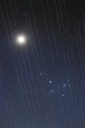 Satellites leave light streaks in the sky.